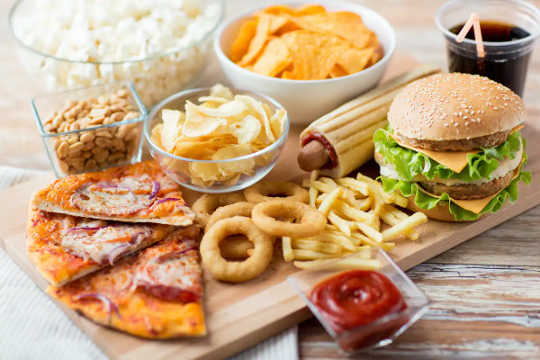 Pizza, a cheeseburger, onion rings, and other unhealthy foods.