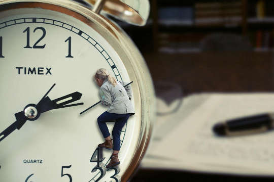 a woman climbing on a clock 